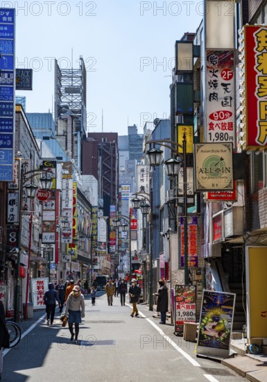 Lots of colorful signs of shops, restaurants and bars in a street, Shinjuku City, Tokyo, Japan