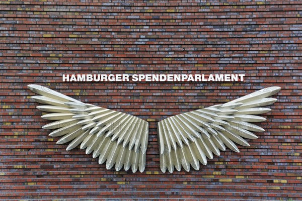 Facade with wings, sculpture, Hamburger Spendenengel artwork, inscription Hamburg Donations Parliament, social projects against poverty, homelessness and isolation, Westfield Überseequartier, modern shopping center, HafenCity, Hamburg, Germany