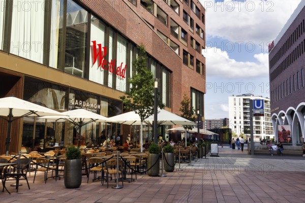 Street café with lettering, passers-by, subway station, Westfield Überseequartier, modern shopping center, HafenCity, Hamburg, Germany