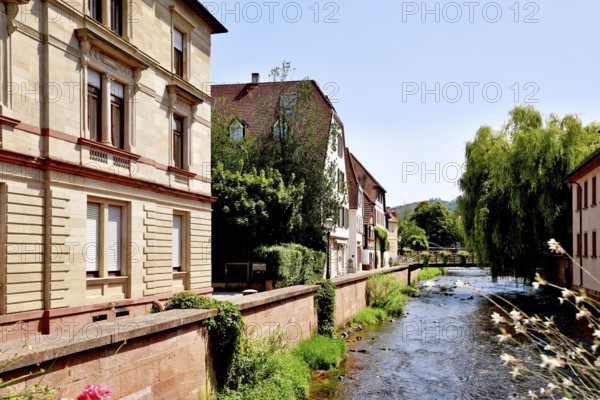 Ettlingen, Germany - August 13th 2025: Alb brook in historic center of Ettlingen, Germany. Small creek with old buildings
