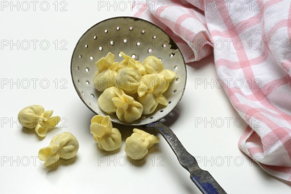 Saccottini, type of Italian pasta in a sieve ladle, pasta from Italy