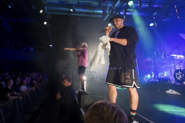 Mal Élevé (Pablo Charlemoine) and Carlito (Carlos Charlemoine), singer of Irie Révoltés live on Irieunion - Le Re-Tour pour une année! Tour in Berlin's Columbiahalle on 31.10.2025