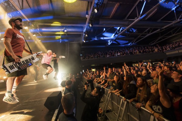 Chriggi (Christian Comba, keyboardist), Mal Élevé (Pablo Charlemoine, singer) and Carlito (Carlos Charlemoine, singer) from Irie Révoltés live on Irieunion - Le Re-Tour pour une année! Tour in Berlin's Columbiahalle on 31.10.2025