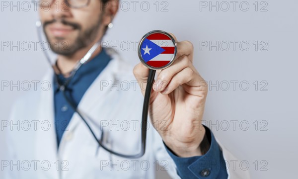 Doctor holding stethoscope with Puerto Rico flag. Puerto Rico health and care concept. Puerto Rico flag on stethoscope