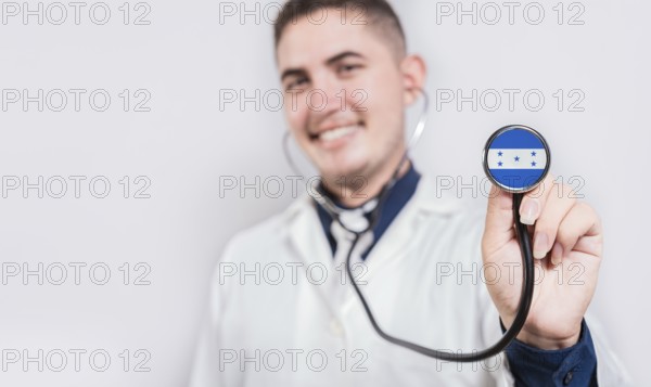 Doctor showing stethoscope with Honduras flag. Honduras national healthcare concept