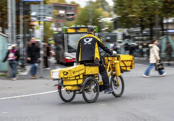 Delivery agent, Deutsche Post mailman on e-bike, Bochum, North Rhine-Westphalia, Germany