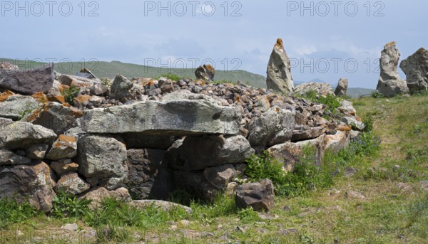 Stone wall with stones stacked on it in a green landscape, stone circle, megaliths, Zorats Karer, Karahundsch, Bronze Age burial ground, Sisian, Sisian, Sjunik province, historic Sangesur, Armenia