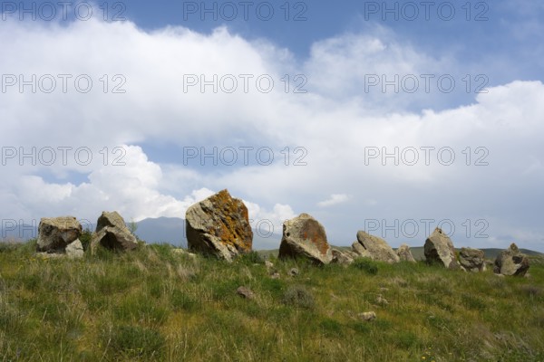 Stone formations in a meadow under a cloudy sky, stone circle, megaliths, Zorats Karer, Karahundsch, Bronze Age burial ground, Sisian, Sissian, Syunik province, historical Sangesur, Armenia