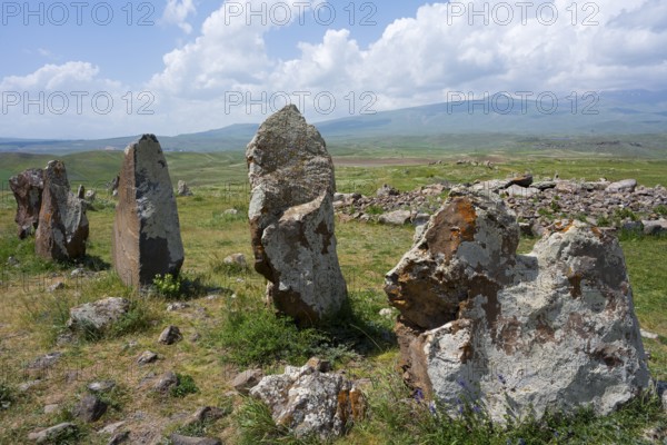 Set of stones in a vast landscape with mountains and clouds in the background, stone circle, megaliths, Zorats Karer, Karahundsch, Bronze Age burial ground, Sisian, Sisian, Syunik province, historical Sangesur, Armenia