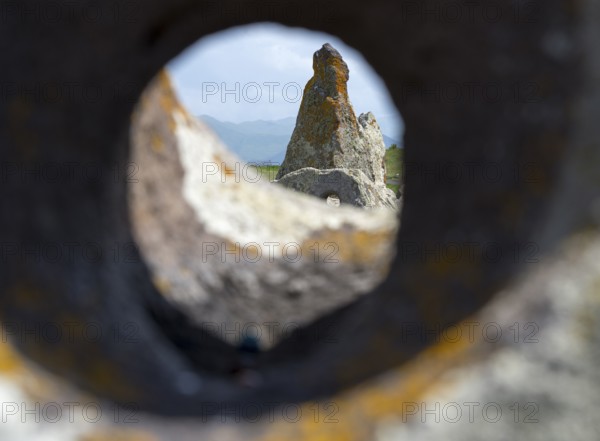 Stone block with hole that allows a view of stones and landscape behind it, stone circle, megaliths, Zorats Karer, Karahundsch, Bronze Age burial ground, Sisian, Sisian, Sjunik province, historical Sangesur, Armenia