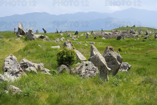 Stone blocks on a green meadow with hills and mountains in the background, stone circle, megaliths, Zorats Karer, Karahundsch, Bronze Age burial ground, Sisian, Sisian, Sjunik province, historic Sangesur, Armenia