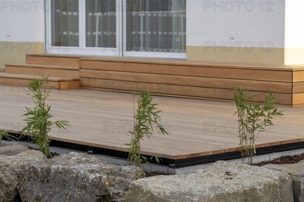Beautiful wooden terrace on a newly landscaped garden