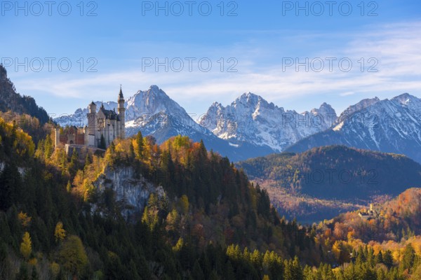 Neuschwanstein shimmers in front of the majestic Alps in a colorful autumn landscape, Schwangau near Füssen, Ostallgäu, Allgäu, Bavaria, Germany