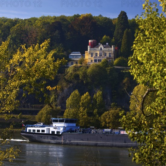 Marienfels Castle with cargo ship on the Rhine River, former residence of entertainer Thomas Gottschalk, Remagen, Rhineland-Palatinate, Germany