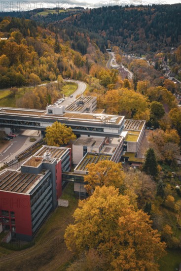 Large building seen from above, surrounded by forest and roads, Calw District Office, Calw, Germany