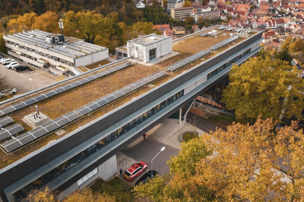 Building with solar technology on the roof, surrounded by autumn surroundings, Calw District Office, Calw, Germany