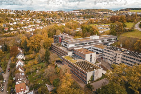 Building complex in autumn surroundings, aerial view with city view, Calw District Office, Calw, Germany
