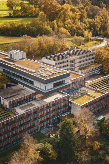Modern buildings with green roofs in the midst of an autumn landscape, Calw District Office, Calw, Germany
