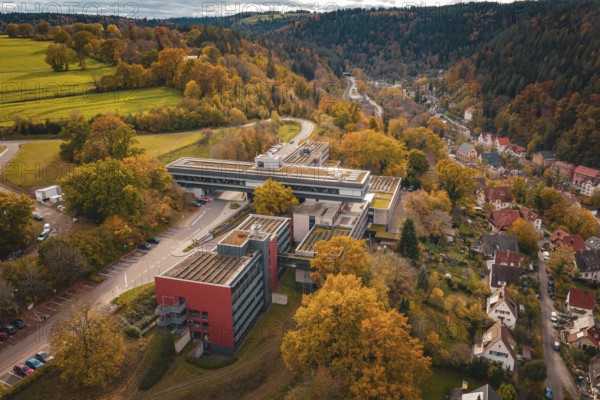 Aerial view of a large building in an autumn landscape with roads, Calw District Office, Calw, Germany