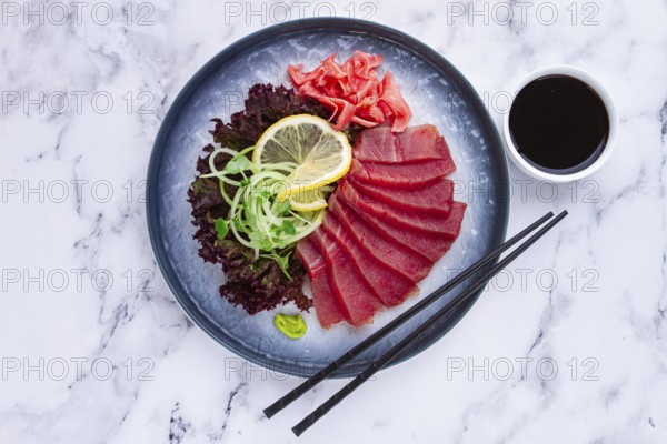 Tuna sashimi, with side dish, on a marble table, homemade, no people