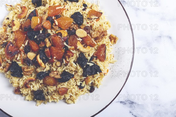 Rice dish, with the addition of dried fruits, nuts and spices of Middle Eastern cuisine, homemade, no people