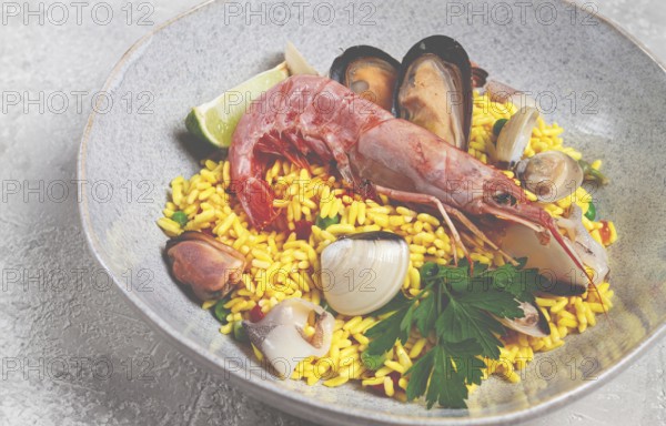 Seafood paella, on a plate, traditional Spanish dish, top view, no people