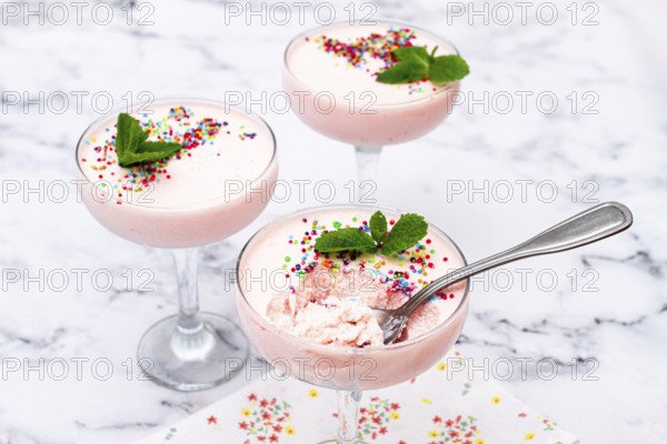Fruit mousse, made from jelly and cottage cheese, in glasses, decorated with sprinkles and mint, homemade