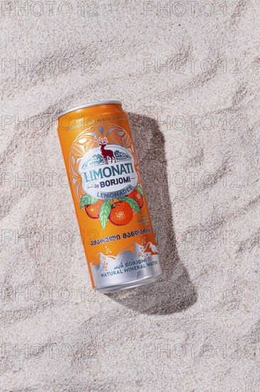 Adjara mandarin lemonade, Borjomi, aluminum can, on the sand, sunlight, close-up