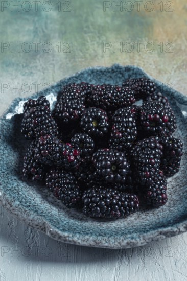 Fresh blackberry berry, on a plate, top view, no people