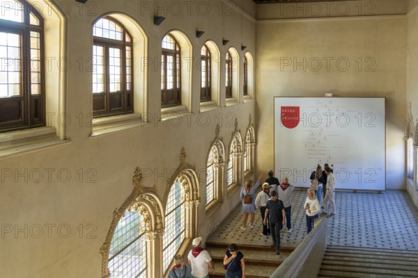Visitors viewing wall chart of genealogy of Kings of Aragon, Aljafería Palace, Zaragoza, Aragon, Spain