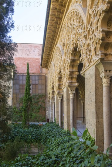 Ornate Islamic design decorated Moorish arches, courtyard garden of Santa Isabel, Aljafería Palace, Zaragoza, Aragon, Spain
