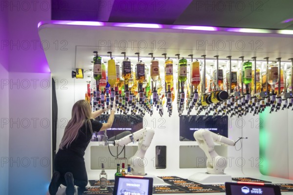 Las Vegas, Nevada - Robotic bartenders mix and serve drinks at the 'Tipsy Robot' in the Venetian Resort. A real person replaces empty liquor bottles
