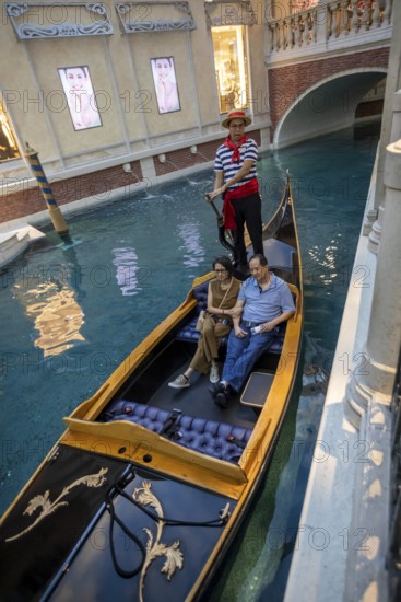 Las Vegas, Nevada - A couple rides on a gondola on the indoor canals at The Venetian Resort