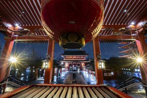 View from the main hall with a huge red lantern to the illuminated Hozomon Schazkammer Gate of Asakusa Shrine or Senso-ji Temple, at night, Buddhist temple complex, Asakusa, Tokyo, Japan