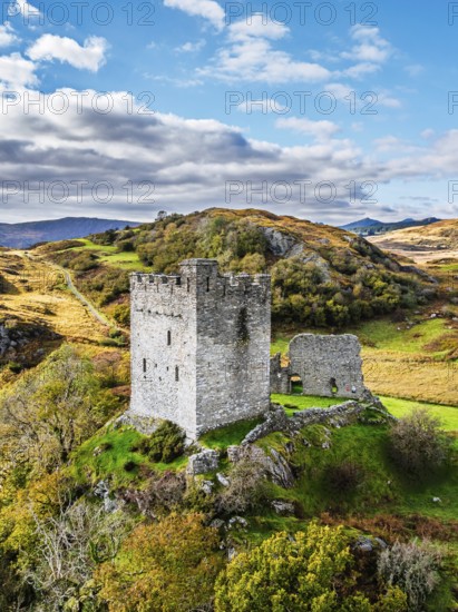 Autumn colours over Castell Dolwyddelan and Eryri Mountains from a drone, Snowdonia, Conwy County Borough, Wales, England, United Kingdom