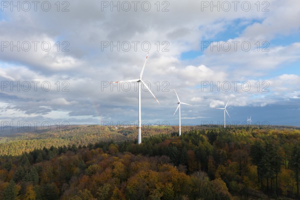 Three wind turbines above a colorful autumn forest under a cloudy sky, near Schorndorf, Remstal, Rems-Murr-Kreis, Baden-Württemberg, Germany