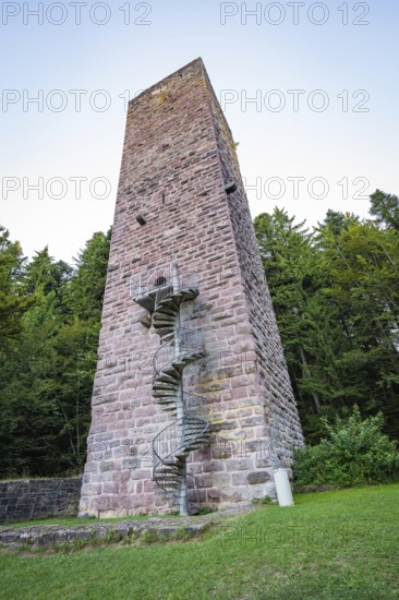 A tall stone tower with spiral staircase in the middle of a wooded area at dusk, Mandelberg Castle Ruins, Pfalzgrafenweiler, Freudenstadt District, Germany