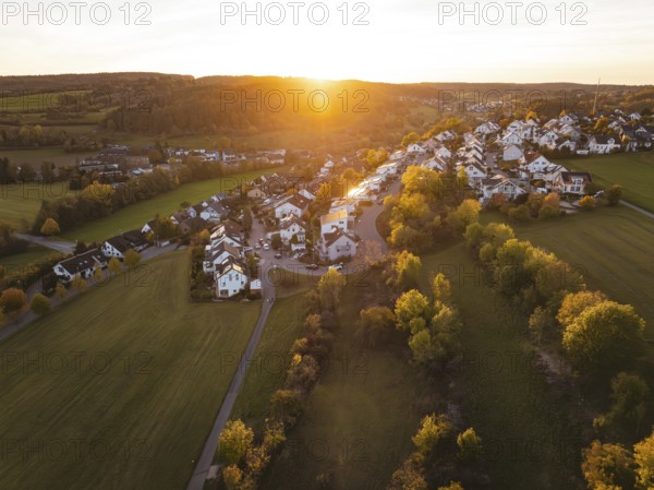 Village surrounded by trees with warm autumn atmosphere at sunset, Deufringen, Aidlingen, Böblingen district, Germany