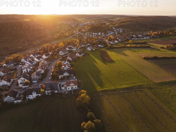 Wide view of a village on a sunny autumn evening with fields and hills, Deufringen, Aidlingen, Böblingen district, Germany