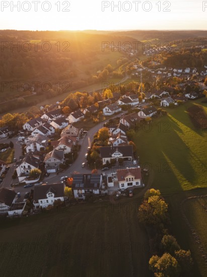 Aerial view of a village in the light of the setting sun with fields in the background, Deufringen, Aidlingen, Böblingen district, Germany