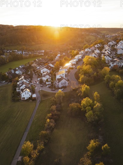 Village in evening light, surrounded by autumn trees and soft light, Deufringen, Aidlingen, Böblingen district, Germany