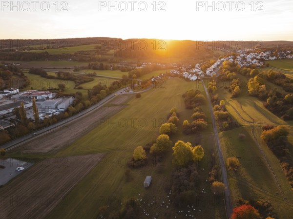 Wide fields with a village in warm autumn light at sunset, Deufringen, Aidlingen, Böblingen district, Germany
