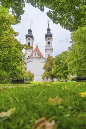 View of a church with two towers surrounded by lush green trees and well-kept lawn, ZFP Zwiefalten, Reutlingen district, Germany