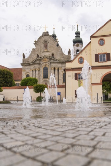 Historic church with fountain in the foreground, baroque architecture and cobblestones, ZFP Zwiefalten, Reutlingen district, Germany