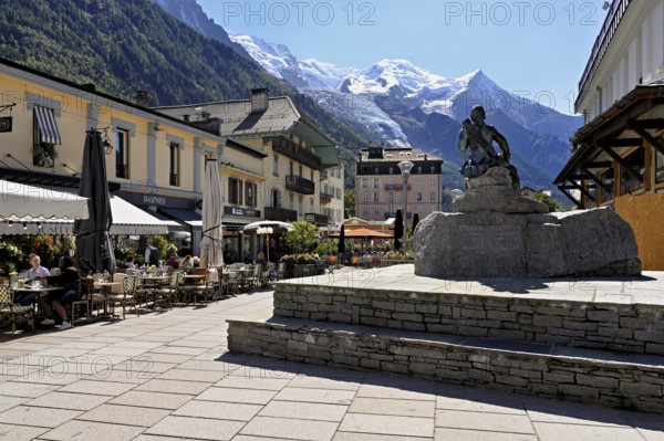 Statue of Michel-Gabriel Paccard, Savoyard doctor and mountaineer, in the back the Mont-Blanc mountain range, Chamonix-Mont-Blanc, Haute-Savoie, France