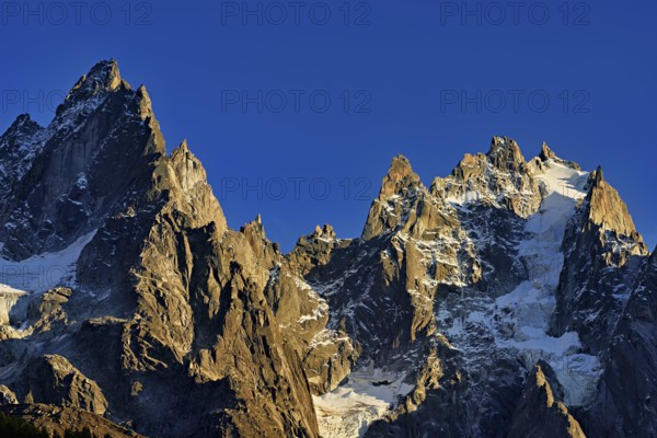 Mountains from the left, Aiguille de Blaitière, Dent du Caïman, Dent du Crocodile, Aiguille du Plan, in the light of the setting sun, Chamonix-Mont-Blanc, Haute-Savoie, Italy Watershed, France
