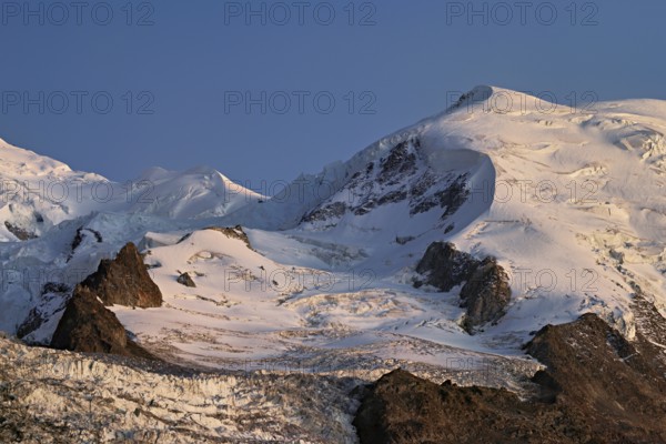 Snow-covered Dome du Goûter, in the evening light, Chamonix-Mont-Blanc, Haute-Savoie, France