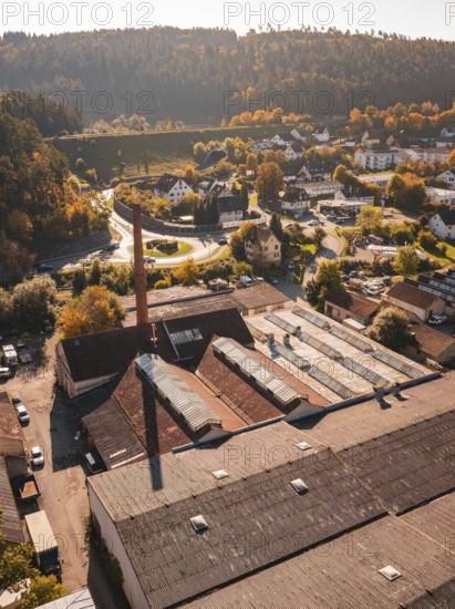 Aerial view of an industrial site in autumn with old buildings and trees, Nagold, Black Forest, Germany
