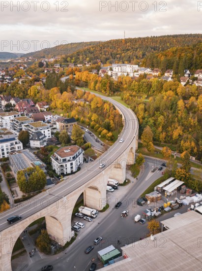 Aerial view of a small town with a viaduct surrounded by forests in autumn colors, Nagold, Black Forest, Germany