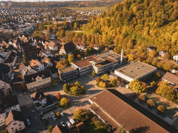 Aerial view of a complex of buildings near an autumn forest, Nagold, Black Forest, Germany